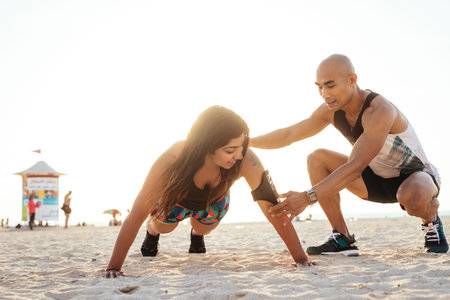 Attractive woman training with the help of a personal trainer.