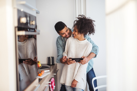 African american couple finding online recipes on a tablet.の写真素材