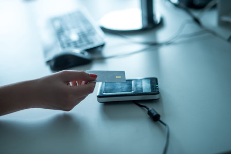 Close up of woman's hand putting a credit card on a machineの写真素材