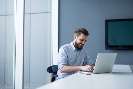 Businessman working on a computer in an office.の写真素材