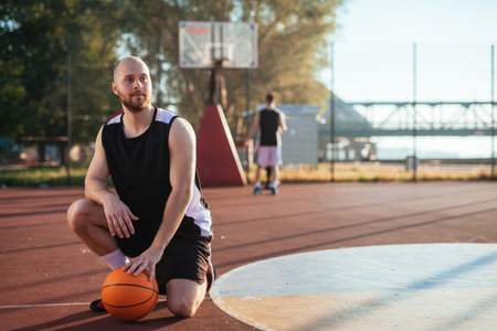 Portrait of a basketball player posing on the court.