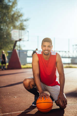 Portrait of an african american basketball player posing on the court.の写真素材