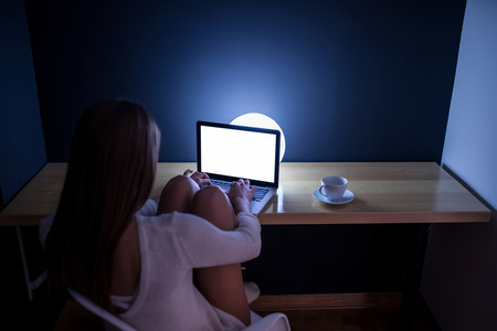 Woman working late at night at home.の写真素材