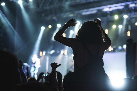 Woman raising her hands on a festival party.の写真素材