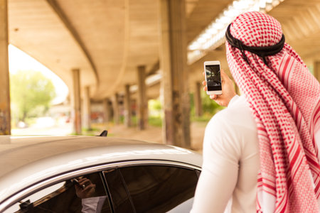 Muslim man photographing outdoors while traveling.