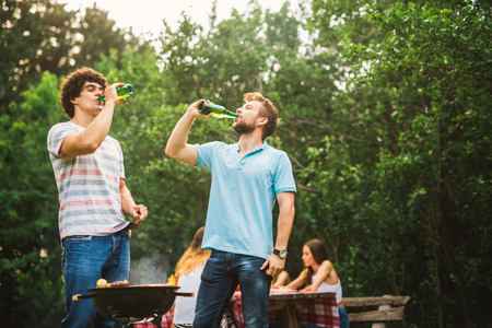 Shot of a group of friends having a barbecue outside.の写真素材