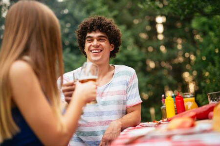Couple toasting together during the lunch with friends.の写真素材