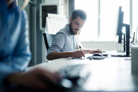 Businessman working on his desk in an office.の写真素材