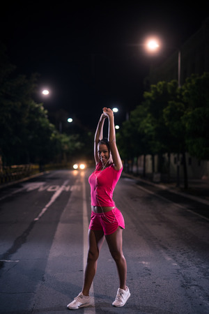 Attractive girl warming up for jogging.の写真素材