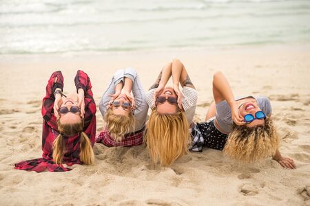 Girls enjoying summer time together on the beach.の写真素材