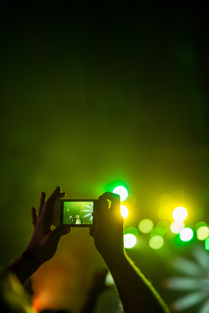 Man capturing moments on a music festival.の写真素材