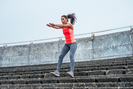 Young beautiful girl exercising outdoors.の写真素材