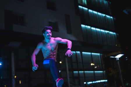 Handsome shirtless man doing fitness at night.