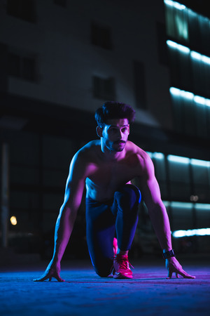 Handsome shirtless man doing fitness at night.の写真素材