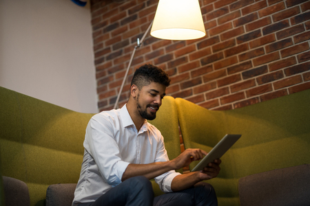 African american businessman working on a tablet in an office.の写真素材