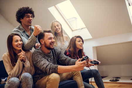 Group of friends playing video games at home.