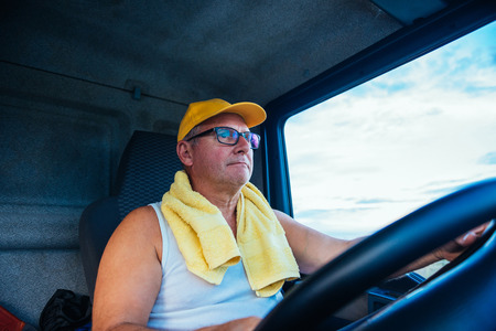 Portrait of a senior truck driver holding a wheel.の写真素材
