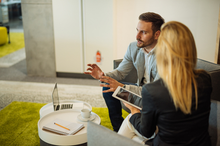 Businesspeople having a casual meeting in the office.の写真素材