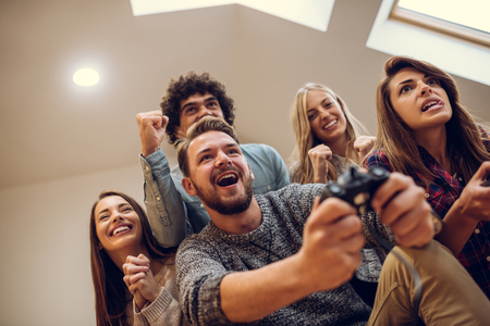 Group of friends playing video games together.の写真素材