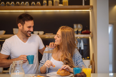 Couple eating a breakfast together at home.の写真素材