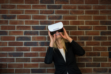 Beautiful young woman using VR glasses in the office.の写真素材