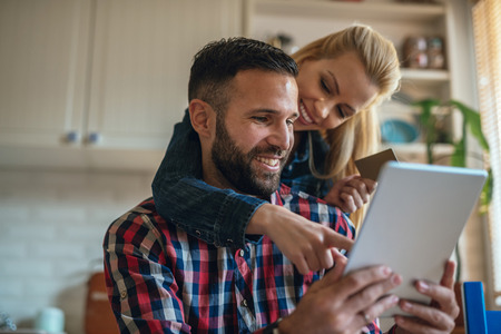 Couple spending money online on the internet.の写真素材