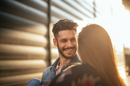 Couple hanging out in the city. The male is carrying his girlfriend.の写真素材