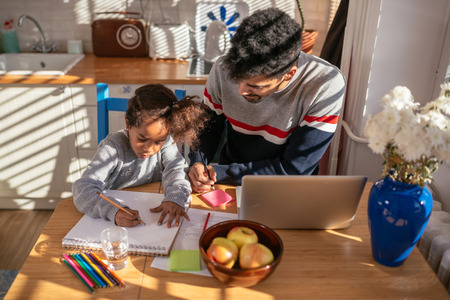 Father and daughter drawing at home.の写真素材