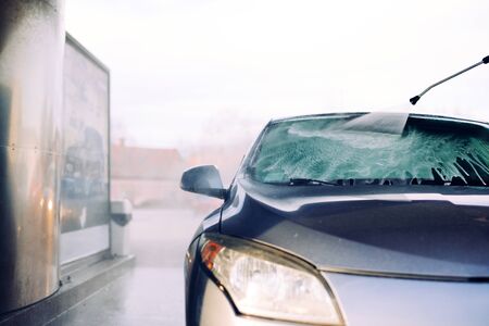 Car Wash Closeup. Washing Modern Car by High Pressure Water.の写真素材