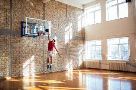 Handsome caucasian basketball player scoring a point.