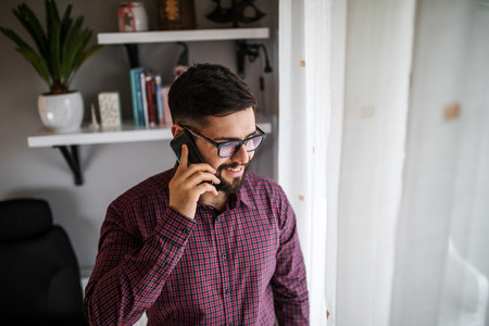 Portrait of a businessman talking on the phone.の写真素材