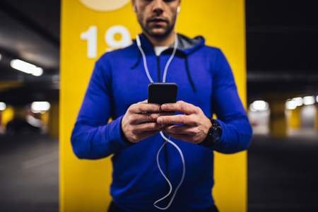 Portrait of an athletic man listening to music underground.の写真素材