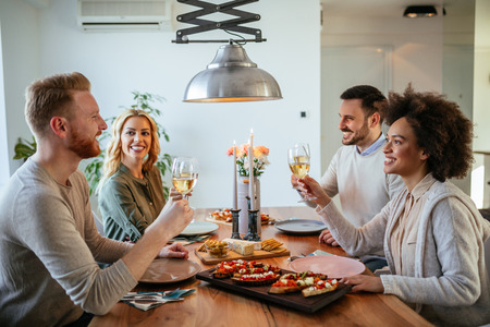 Happy couples enjoying a romantic lunch at home.の写真素材