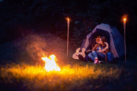 Couple in love enjoying a romantic night camping.の写真素材