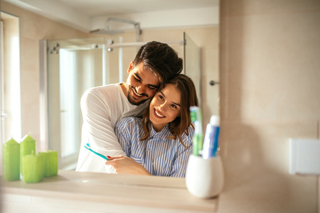 Couple doing a morning hyginene together.の写真素材