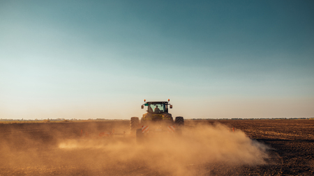 Tractor preparing land for sowing in spring.の写真素材