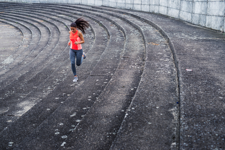 Attractive and young sporty woman running outdoors.の写真素材