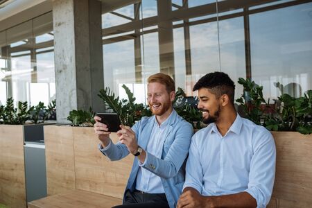 Shot of happy two businessmen using digital tablet.の写真素材