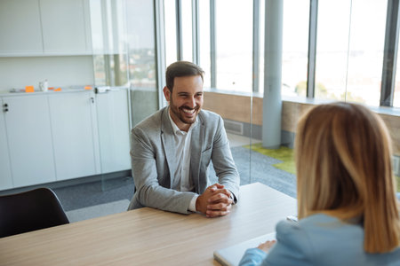 Shot of a satisfied customer talking to a successful consultant in the office.の写真素材