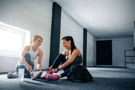 Full length portrait of two athlete women getting ready for a workout together.の写真素材