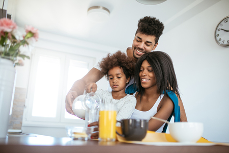 Photo of african american family having breakfast at home.の写真素材