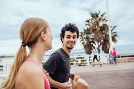 Happy couple enjoying an afternoon jog together.の写真素材