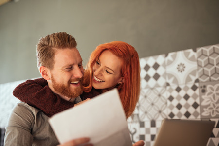 Close up photo of a young couple working together at home.の写真素材