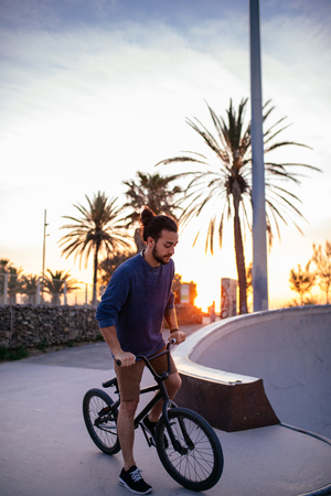 Shot of a man doing tricks on his bike, with sun flare.の写真素材