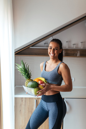 Attractive beautiful woman bringing fruit for breakfast.の写真素材