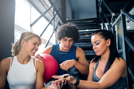 Portrait of three athlete friends preparing for a workout together.の写真素材