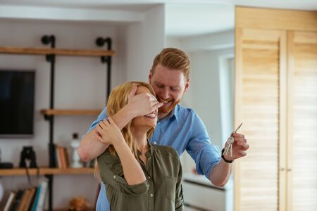 Portrait of a young man surprising his wife with a new house.の写真素材