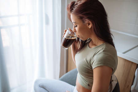 Shot of an attractive young woman enjoying drinking coffee in the morning.の写真素材