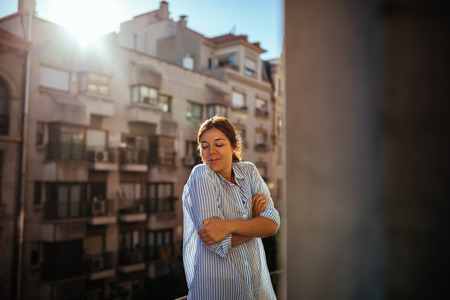 Shot of a woman enjoying on the balcony.の写真素材