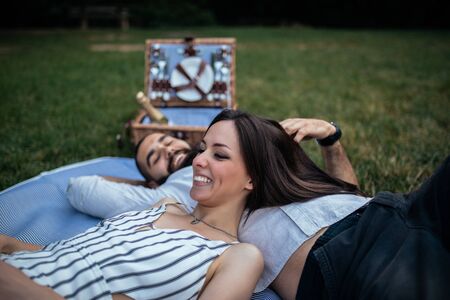 Young couple having a picnic in the woods.の写真素材